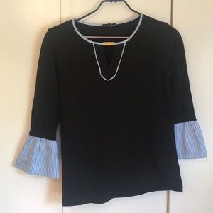 Black top with blue sleeve detail